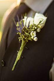 Boutonniere Including Spray Roses Eryngium Wax Flower And Seeded Eucalyptus Wax Flowers Spray Roses Wildflower Wedding
