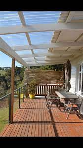The roof extension is usually the case where the second floor extends over the deck area. White Pergola With Clear Lite Roof I Like The Partial Covered Part Closest To The House But Not With The Clear Cover On T Patio Design Pergola Pergola Patio