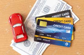 Buying a car can be a reasonable venture that would fit well in your life with easy emis being deducted from your account on a set date every month. Toy Car Credit Cards And Dollars On Wooden Table Cash Repayment And Financial Concept Stock Photo Picture And Royalty Free Image Image 145763275