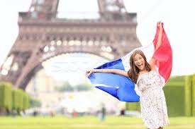 The eiffel tower is an iron tower built on the champ de mars beside the river seine in paris. France French Flag Woman By Eiffel Tower Paris Stock Photo C Ariwasabi 1632359 Stockfresh