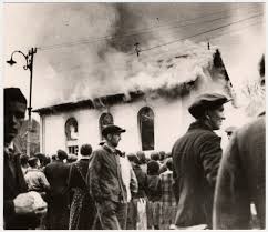 Footage of the dome of the bielefeld synagogue on fire interspersed with shots of bystanders watching it burn from open windows and balconies. History Unfolded Us Newspapers And The Holocaust