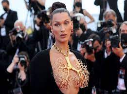 Bella hadid turned heads during the cannes film festival sunday when she arrived wearing a statement piece unlike any other on the red carpet. Sxbtjjztcebgem