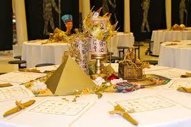 .egyptian decoration and all the treasures that you could find in the tomb of a pharaoh: Placemat Scrolls Made From Internet Egyptian Printouts With Skewers Misc Gold Objects So Egyptian Party Decorations Egyptian Themed Party Egyptian Party