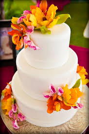 Our lovely sugar flowers look just like the real thing. Bright Edible Flowers On A Wedding Cake For Celebrating Wedding Cakes Cool Wedding Cakes Funny Wedding Cake Toppers