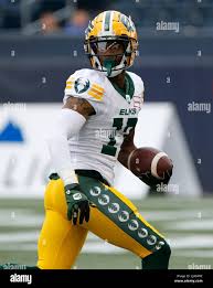 May 27, 2022, WINNIPEG, MB, CANADA: Edmonton Elks' Caleb Holley (17) looks  back as he scores the touchdown against the Winnipeg Blue Bombers during  the first half of pre-season CFL action in