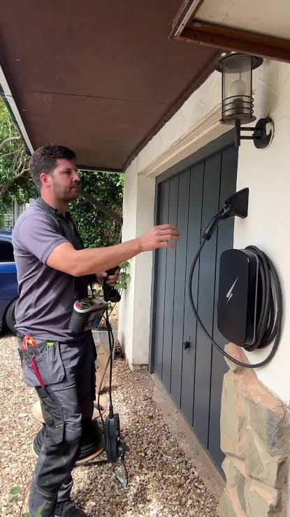 Electrician fitting a base plate for a vehicle access power station in SE28
