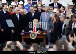 In this Wednesday, Jan. 29, 2020 photo, Al Rehder, left, talks with Larry  Koland in Rehder's car condo at the Eagan Car Club in Eagan, Minn. Behind  Rehder's 1939 Ford is a