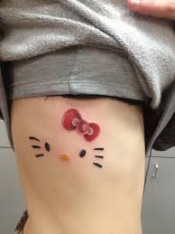It is sitting on a broom stick with a cute purple cape on its back. Tattoo Hello Kitty Design Tattoo Design