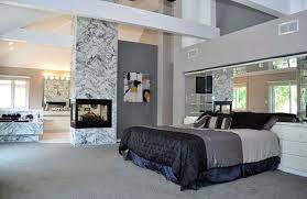 These cupboards being completely flat, no handles, maybe push to open/close design ideas for an expansive modern master bedroom in sydney with light hardwood floors, beige floor and brown walls. Luxury Master Bedrooms With Fireplaces Designing Idea