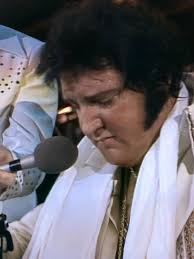 When Elvis walked onto the stage, it was like lightning striking the room.  The arena would go completely dark, a single spotlight would cut through  the silence, and then — suddenly —