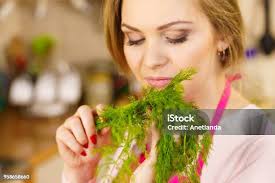Young Woman Holding Dill Herb Stock Photo