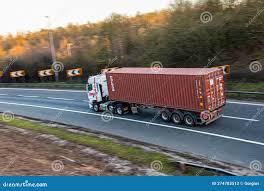 Lorry with Brown Shipping Container in Motion