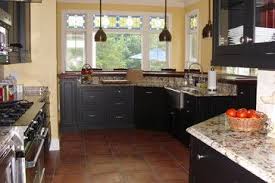 Black cabinets add drama to a kitchen, they can modernize a dated space, and they complement one of the most common concerns with black cabinetry is that a kitchen might look too dark, but pairing black cabinets with blue and yellow tile isn't the most common choice, but here it works. Saltillo Tile Design Ideas Pictures Remodel And Decor Saltillo Tile Tile Design Saltillo Tile Kitchen
