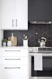 Maybe you would like to learn more about one of these? A Minimalist White Kitchen With A Matte Black Hexagon Tile Backsplash Which Is Accented With W Modern Kitchen Design Kitchen Backsplash Designs Kitchen Design