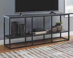 An oak wood grain laminate finish contrasts beautifully with the dark gray metal frame giving this media stand the perfect balance of light and dark. Yarlow 65 Tv Stand Ashley Furniture Homestore Large Tv Stands 65 Tv Stand Contemporary Tv Stand