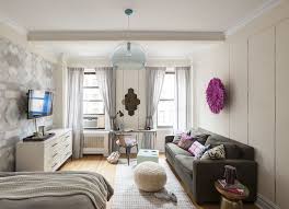 A Long Rectangular Bedroom Is Separated With Area Rug And Wallpaper Studio Apartment Decorating Small Studio Apartment Decorating Apartment Inspiration