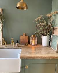 The paint chip shows a more brownish color but on those cabinets, they sure do have a green tone. Dark Green Paint Colors Autumnal Green Inspiration Hello Lovely