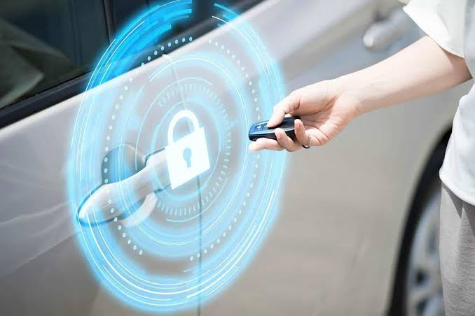 Automotive security technician installing an advanced alarm system in a vehicle