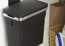 Check out this article for creative ideas to hide or even camouflage your trash can so that it's beautifully integrated. 8 Ways To Hide Or Dress Up An Ugly Kitchen Trash Can