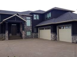 Black And Grey Brick Houses Building New Homes In Central Alberta Larkaun Homes House Exterior Brick Exterior House Stucco Homes