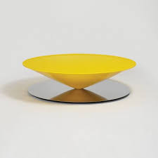 A massive metal cone apparently floats above a mirror polished steel base. Float Coffee Table Yellow Float Is A Sculptural Coffee Table That Challenges Senses And Perception The Geometri Coffee Table Polished Steel Family Furniture