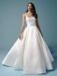 A crown jewel of a design could be big, could be glitzy, or could be a simple satin ball gown wedding dress with pockets. Maggie Sottero Selena Bridal Closet