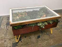 The wood is stained and distressed, which creates a timeless look for any space. Hackney Botanical Makes Plant Filled Tables From Reclaimed Window Frames