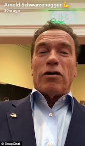 Arnold Schwarzenegger sits at replica of Richard Nixon's desk at the Oval  Office