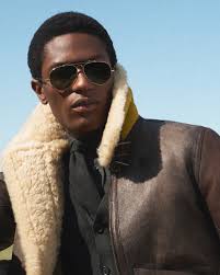 Elements of the #RLPurpleLabel Resort wardrobe. Ralph Lauren styles an  updated iteration of the Hadley blazer—made with cotton terry and  embroidered with a “Ralph's Beach Club” crest—with a striped Polo sweater  and