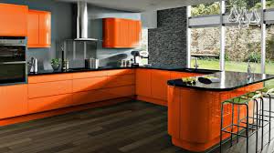 A modern style orange kitchen, with a sleek breakfast island, bar type stools, and tiled floors. 20 Orange Kitchens That Will Blow You Away