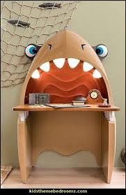 When designing a kids' theme room, it's best to keep strong design elements such as sharks, dinosaurs or pirates in a balanced proportion to create a cohesive design. Decorating Theme Bedrooms Maries Manor Shark Bedrooms Shark Murals Shark Decor Shark Wall Decal Kids Bedroom Furniture Kids Study Desk Kids Furniture