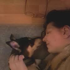 The kitten calms down while drinking milk with his human brother, they give  him a small bottle and they fall asleep.