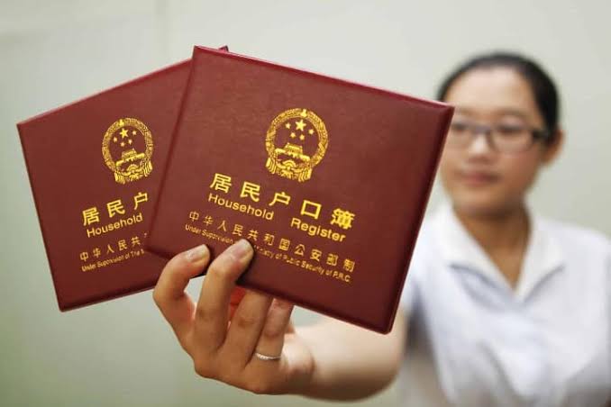 8. Mujer sosteniendo registros Hukou. Foto - The Wire China | El Souvenir