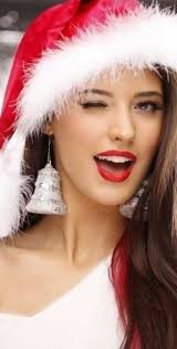 Pretty young brunette woman dressed as santa blowing on the snow on her hands. Pin On My Most Repined Pins