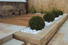 Gravel is one of the most versatile landscape materials, as it can be used as anything from a pathway material to mulch. Raised Sleeper Beds Back Garden Design Backyard Landscaping Designs Backyard Garden Design