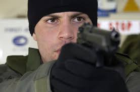 US Marine Corps (USMC) Private First Class (PFC) Benjamin Leichty, a member  of the Special Reaction Team (SRT), aims his M9 9mm handgun, during a  routine training exercise, held aboard Marine Corps
