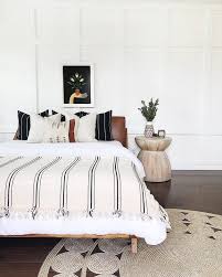 Black And White Bedroom With Wood Furniture The Leather Headboard In This Bedroom Is Surprisingly Sleek And Available Online Hunker White And Brown Bedroom White Bedroom Decor Leather Bedroom