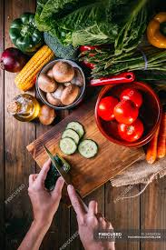 Assuming you can shorten the top without affecting the base: Human Hands Cutting Fresh Vegetables On Wooden Chopping Board On Kitchen Table Surface Organic Stock Photo 244032326