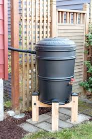 Reach inside the barrel and add a rubber and metal washer onto the other end of the spigot. Diy Rain Barrel Stand The Handyman S Daughter