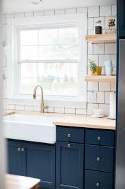 A pretty blue kitchen with a grey floral wallpaper wall and touches of gold and stained wood is vintage chic. Kitchen Reno Light Blue Kitchens Butcher Block Countertops Kitchen Blue Kitchen Cabinets
