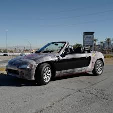 New toy! Bought a 1991 Honda Beat, a Japan-only convertible with a 660cc 3  cylinder engine that revs to 9000rpm. It's so tiny, and so much damn fun.  Wrapped it to look