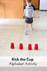 Fun toddler activities can include anything from blowing bubbles, kicking a ball to toddler lesson plans can include a wide range of subjects such as literature, speech, nursery rhymes, songs, crafts, nature and physical exercise. Ball Theme Alphabet Activity Kick The Cup Alphabet Activities Preschool Motor Skills Activities Alphabet Activities