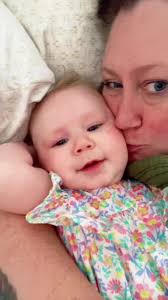 Mom Listening to Nora James with Her Baby