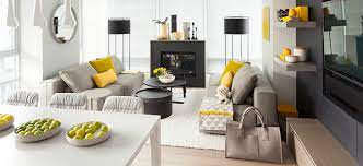 Gray and yellow striped chairs bring neutral tones to the deep tones of the rest of the decor. A Twist Of Lemon Add Some Vibrant Yellow In Your Living Room