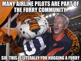 Tommy Tuberville in 2026: 'Many airline pilots are part of the furry  community, it's terrifying!' Also Tommy Tuberville: see photo below 👇🏻  👇🏻 👇🏻 Sir, you LITERALLY made a career hugging Aubie."