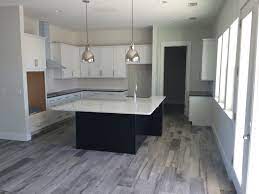 This traditional neutral toned kitchen features a harmonious color scheme of light wood cabinets for storage and neutral tile floors. 8 X32 Wood Look Tile Get The Wood Look You Love Anywhere In Your Home Even Wet Areas Like K Wood Tile Floor Kitchen Wood Tile Kitchen Kitchen Floor Tile