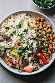 Moroccan Spiced Chickpea Veggie Bowl With Mango Tahini Sauce Simple Natural Nutrition Recipe Vegetarian Recipes Spiced Vegetables Veggie Bowl