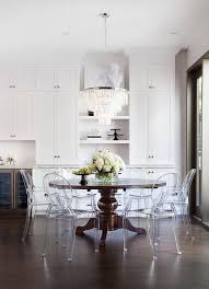 Kartell Host Chairs Surround Brown Round Traditional Dining Table Placed Beneath A Traditional Dining Tables Brown Dining Table Traditional Dining Room Chairs