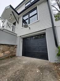 As shown here, curb appeal is transformed for these homeowners with a new steel garage door with flush panels and long windows stacked vertically. Monroe Ct J A G Sons Overhead