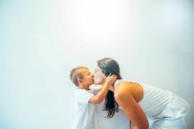 Mother and son kissing stock photo